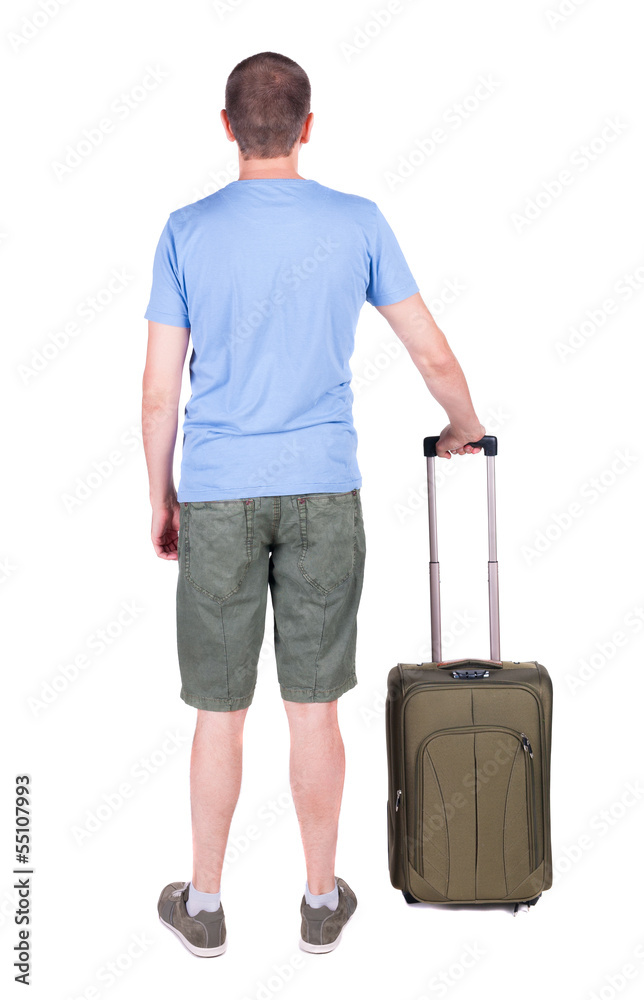 Back view of man with green suitcase looking up.