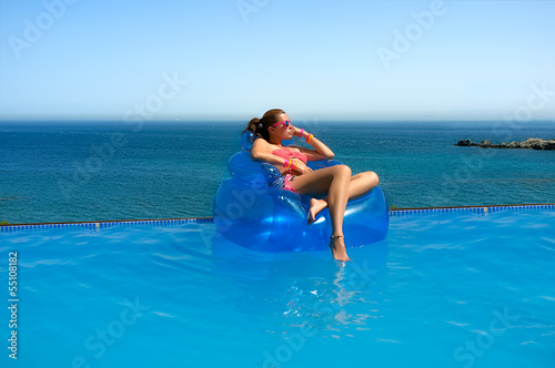 Fashionable Girl Relaxing in the Pool. Summer Vacation