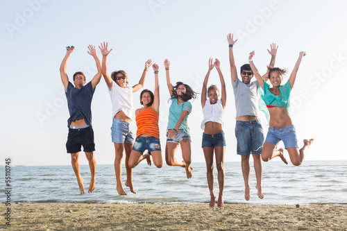 Multiethnic Group of People Jumping at Beach