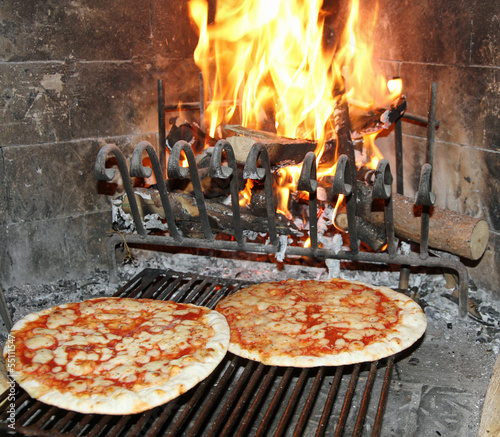 excellent fragrant pizza baked in a wood fireplace with a wood-b
