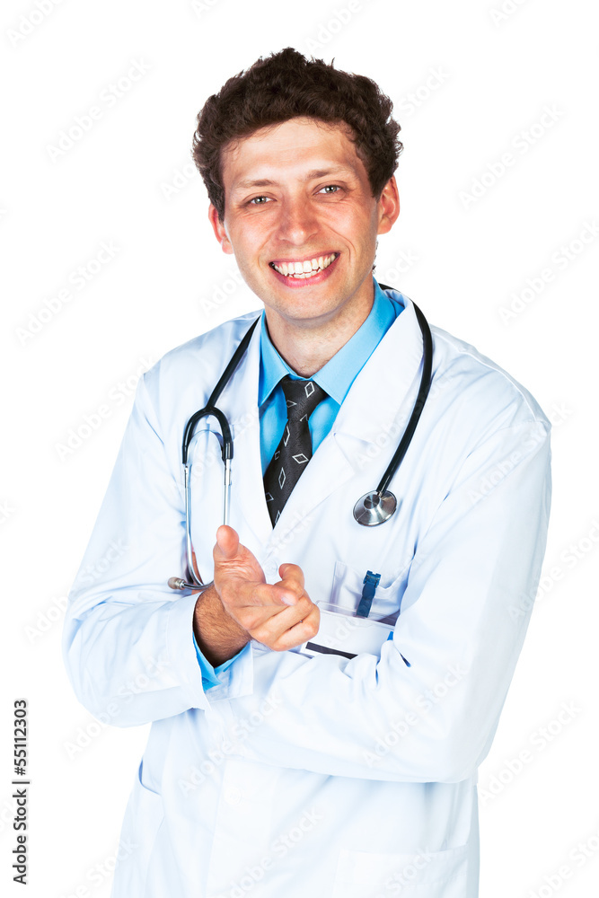 Portrait of a smiling male doctor showing finger at you on white