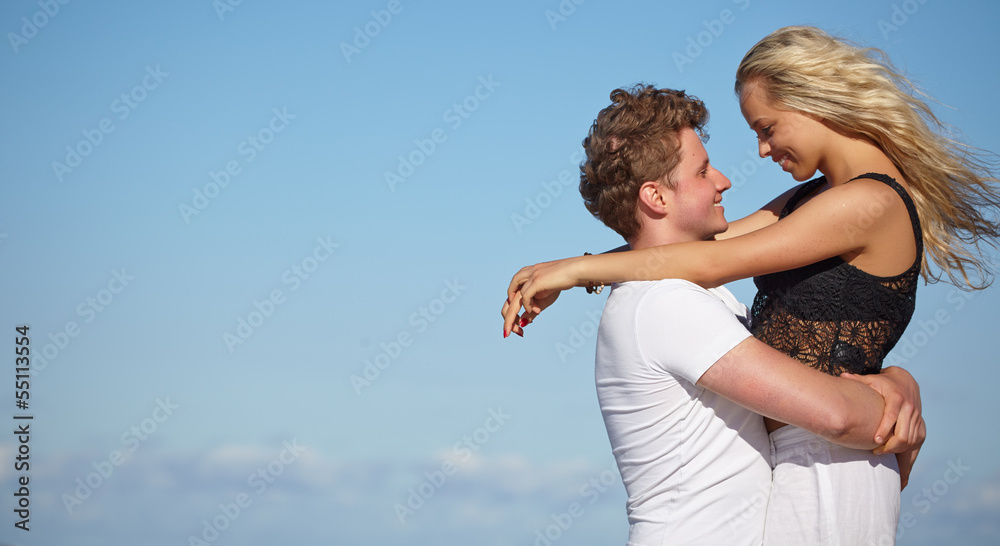 Young happy couple having fun on the beach. Young happy couple having fun on the beach.