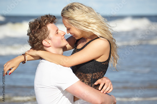 Young happy couple having fun on the beach.