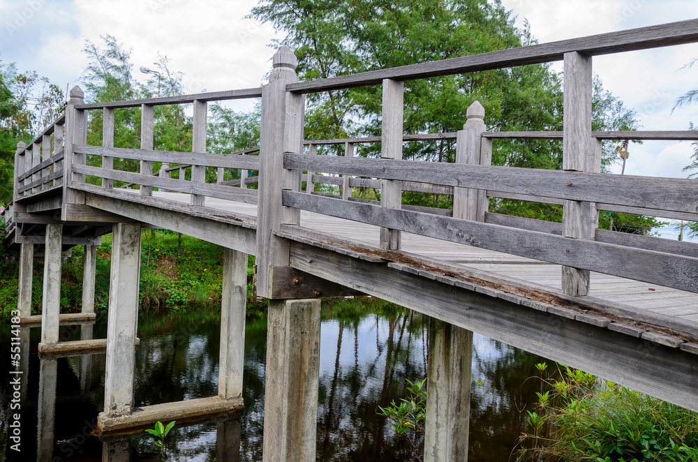 Old wooden bridge over the small river