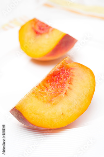 slice of fresh peach on a plate, close-up