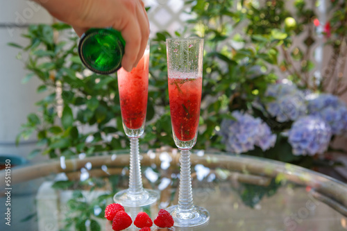 Summer cocktail with champagne and fresh raspberries