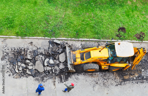 tractor removes asphalt
