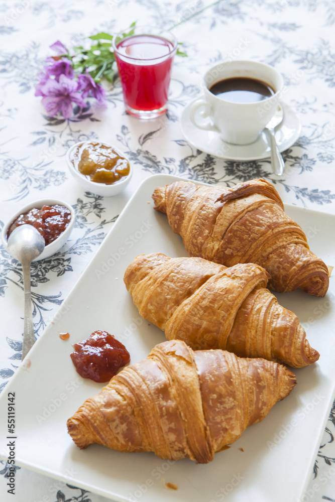 Croissants on table with jam, orange juice and coffee Croissants on table with jam, orange juice and coffee
