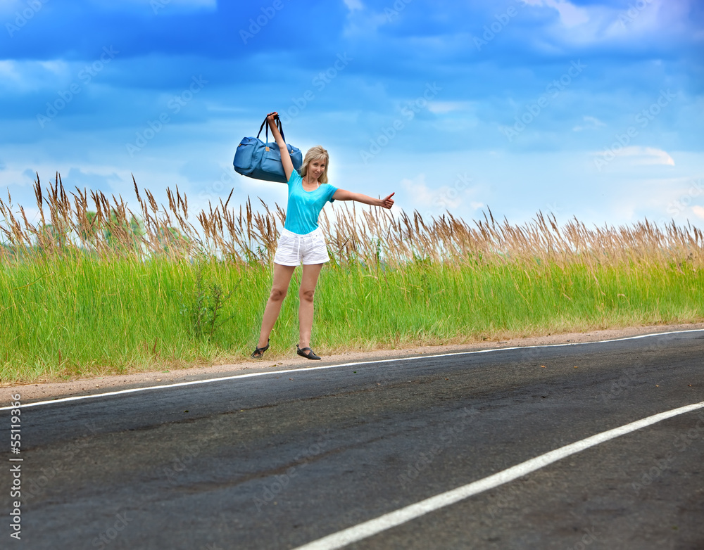 Hitchhiking girl votes on road..