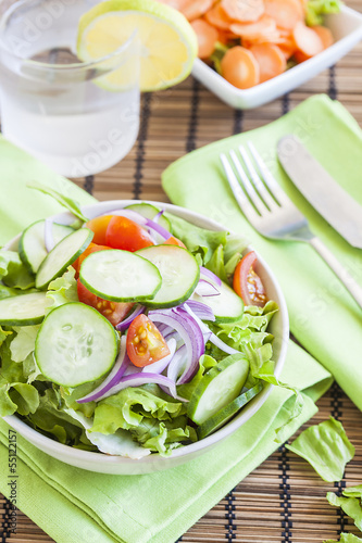 fresh green salad with cucumber, tomato and red onion.