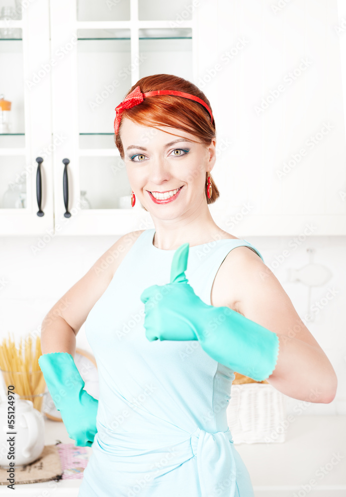 Happy housewife with rubber gloves showing thumbs up Happy housewife with rubber gloves showing thumbs up