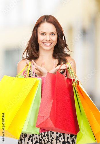 woman holding color shopping bags in mall