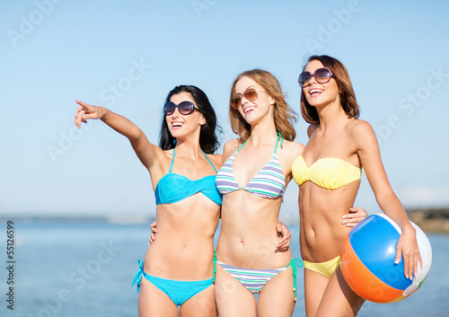 girls with ball on the beach