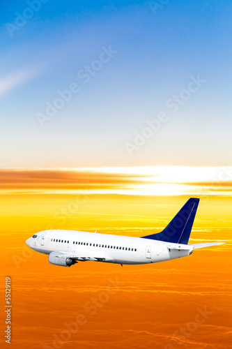 Airplane in the sky at sunset. A passenger plane in the sky