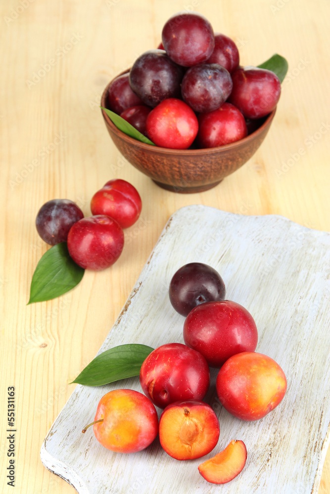 Ripe plums on wooden table close-up Ripe plums on wooden table close-up