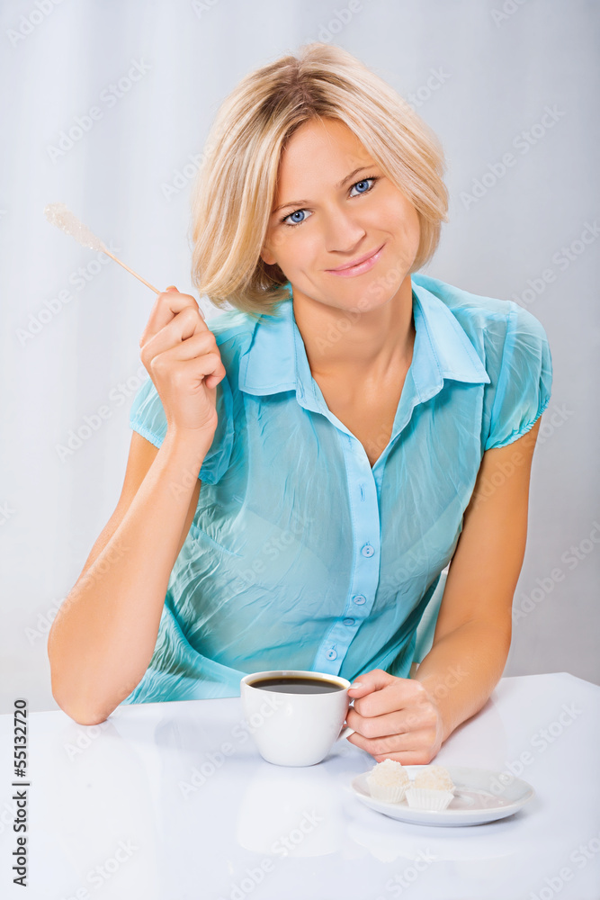 beautiful blonde holding sugar stick and coffee cup beautiful blonde holding sugar stick and coffee cup