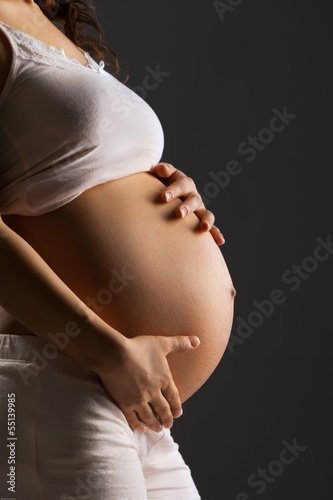 Pregnant woman caressing her belly