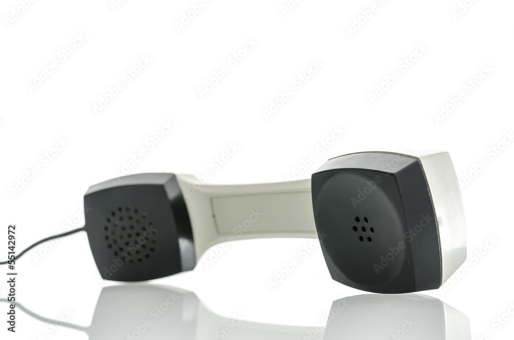 Telephone receiver on white desk Telephone receiver on white desk