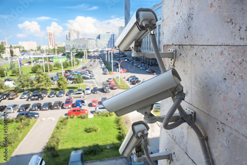 Video surveillance cameras on wall looking at street area