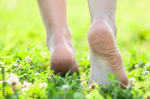 Bare feet on the soft summer grass