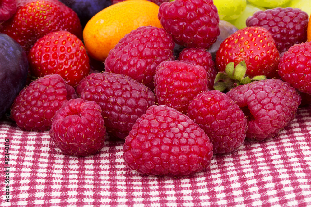 tasty summer fruits on a red tablecloth tasty summer fruits on a red tablecloth