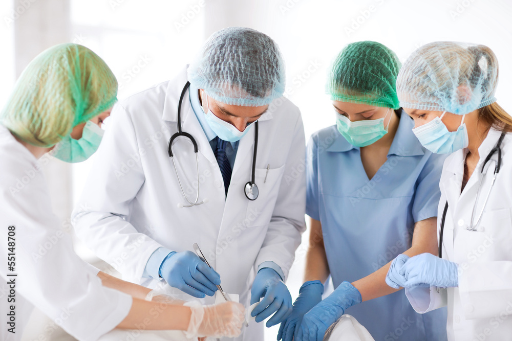 young group of doctors doing operation young group of doctors doing operation