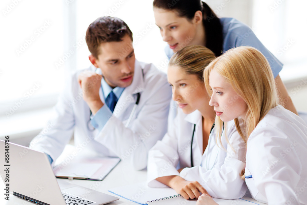 group of doctors looking at tablet pc group of doctors looking at tablet pc