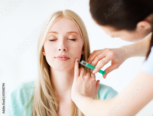Beautician with patient receiving cosmetic injection