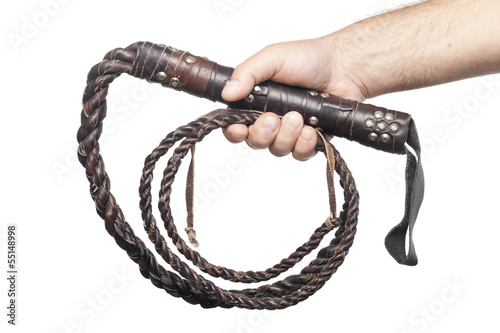 male hand holding brown leather whip isolated on white backgroun photo