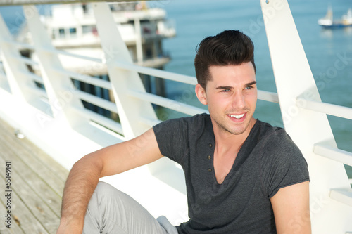 Handsome young man relaxing outdoors on a summer day Free Download Handsome young man relaxing outdoors on a summer day - GFXLoad