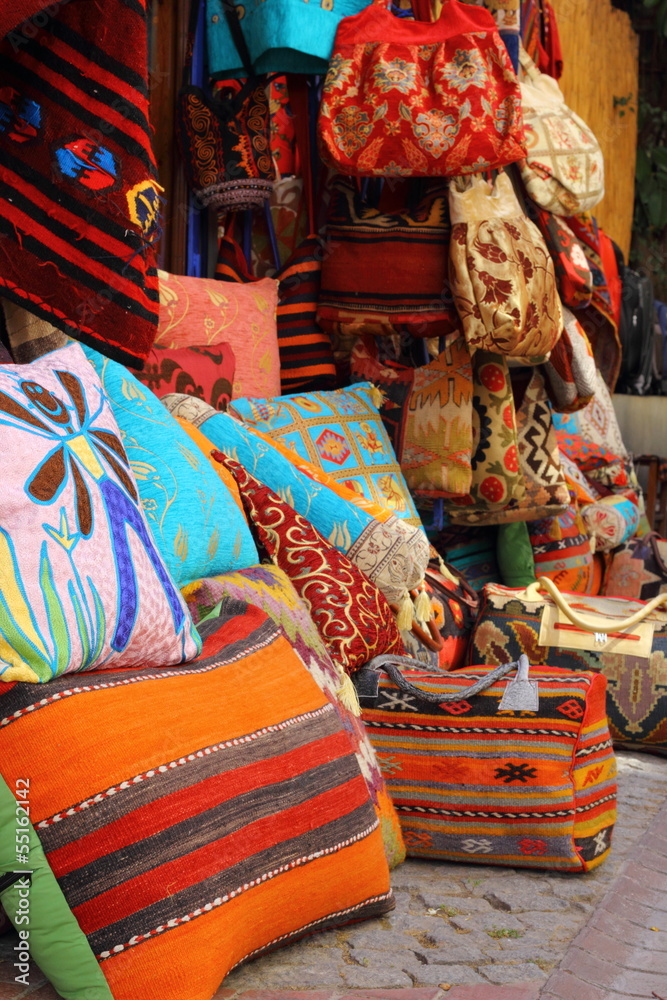 Fabrics, textiles and turkish rugs at a bazaar in Turkey