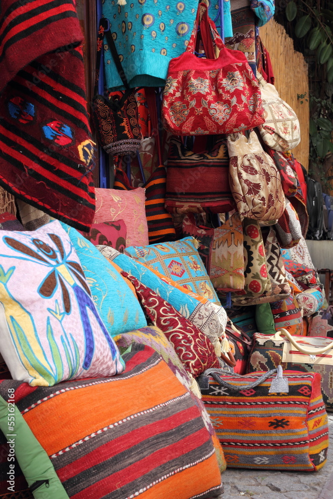 Fabrics, textiles and turkish rugs at a bazaar in Turkey
