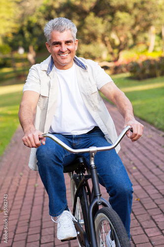 middle aged man riding a bike