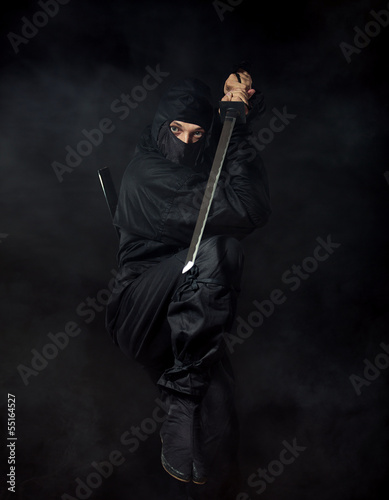 Ninja with sword on black in smoke