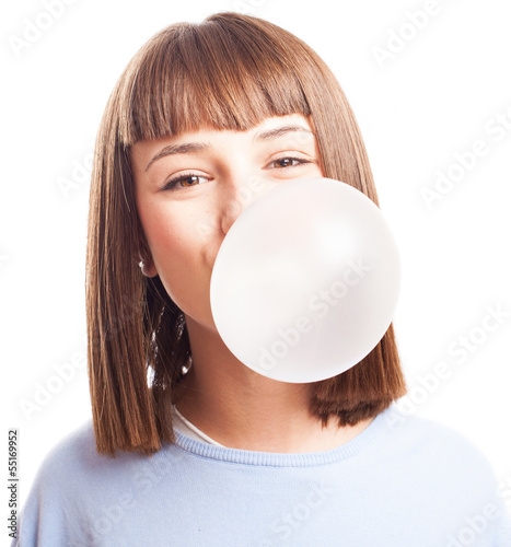 Fotografie girl doing a bubble with a chewing gum on a white background