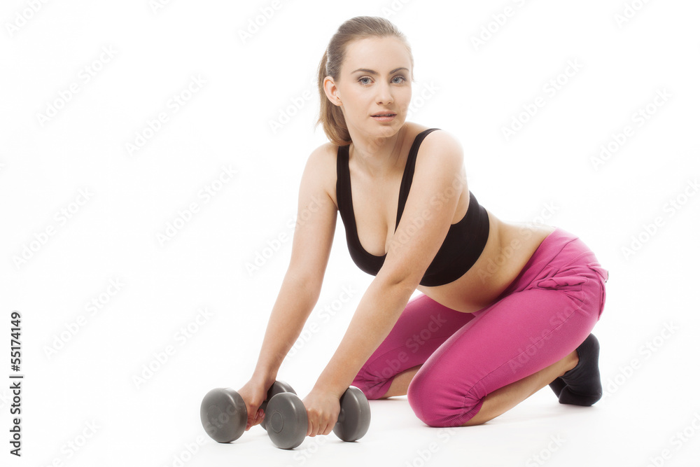 Obraz Young woman holding weights and doing fitness fototapeta, plakat