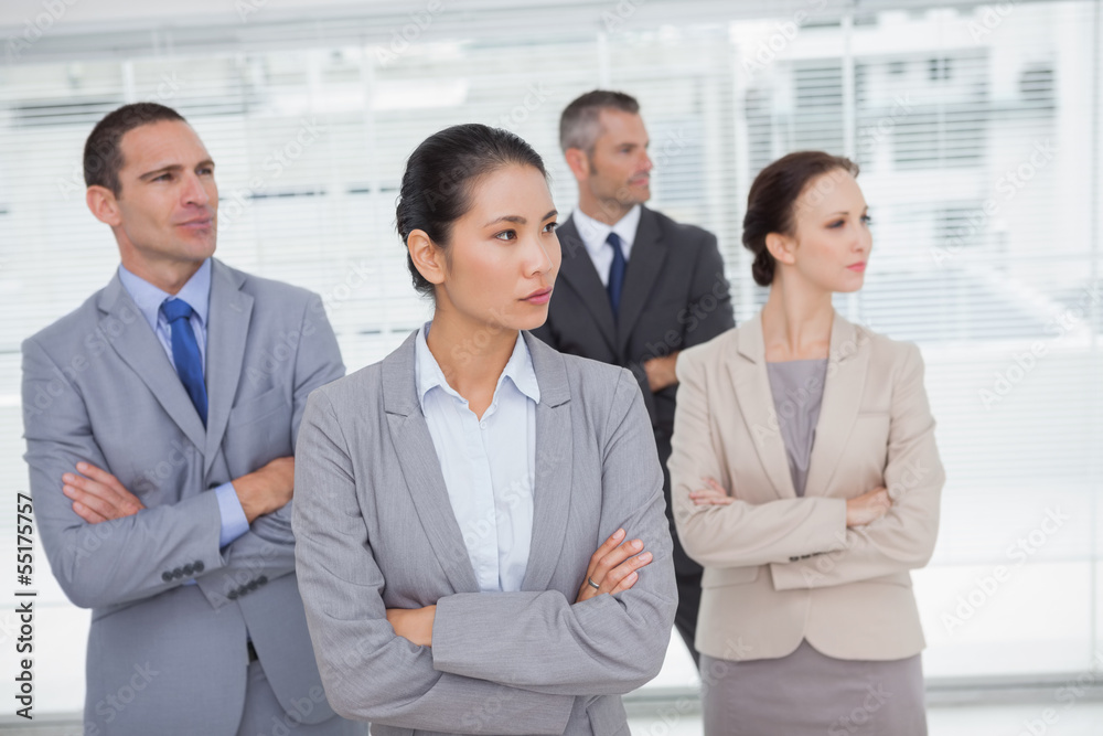 Stern work team crossing arms and looking away Stern work team crossing arms and looking away