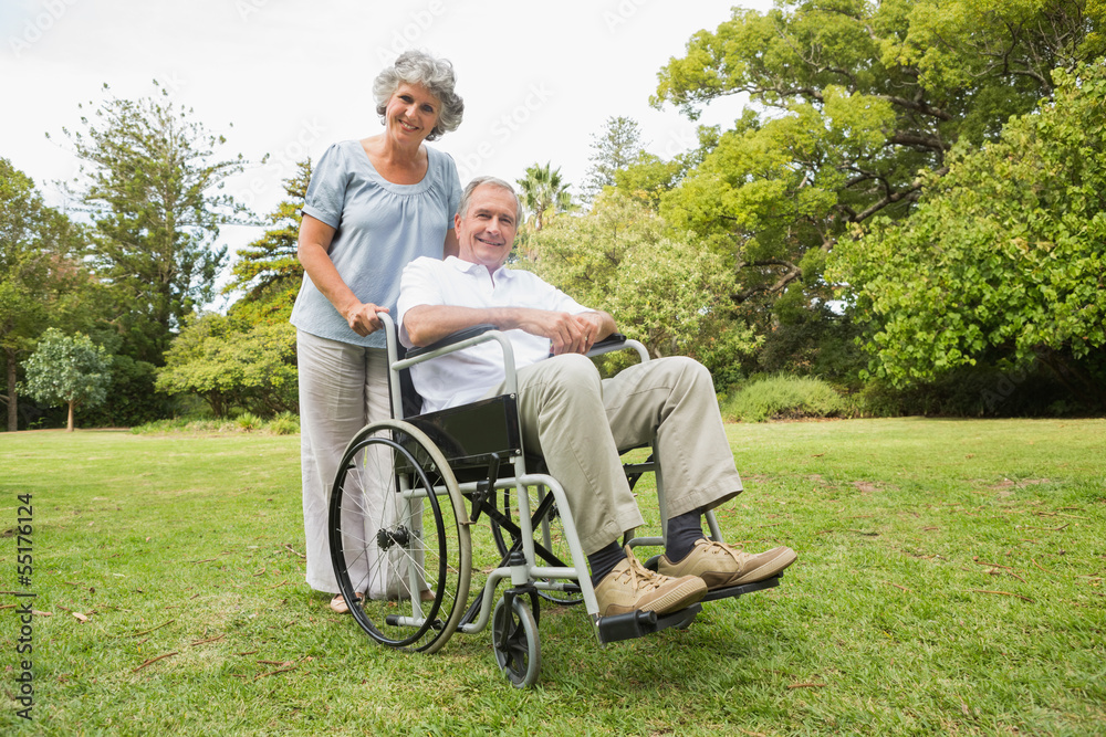 Happy mature man in wheelchair with partner Happy mature man in wheelchair with partner