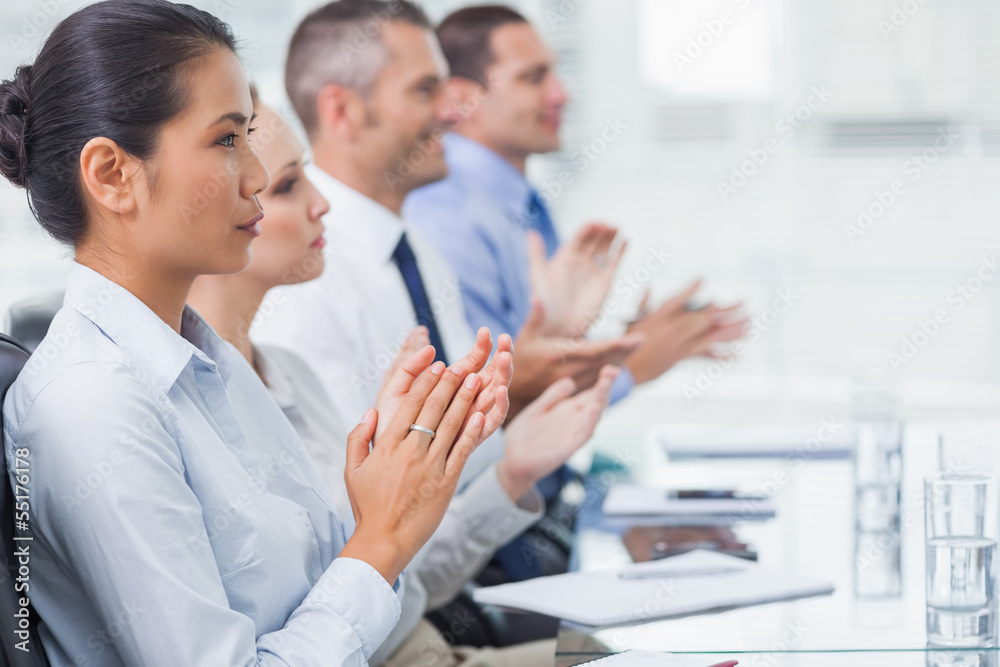 Serious employees applausing for a presentation Serious employees applausing for a presentation
