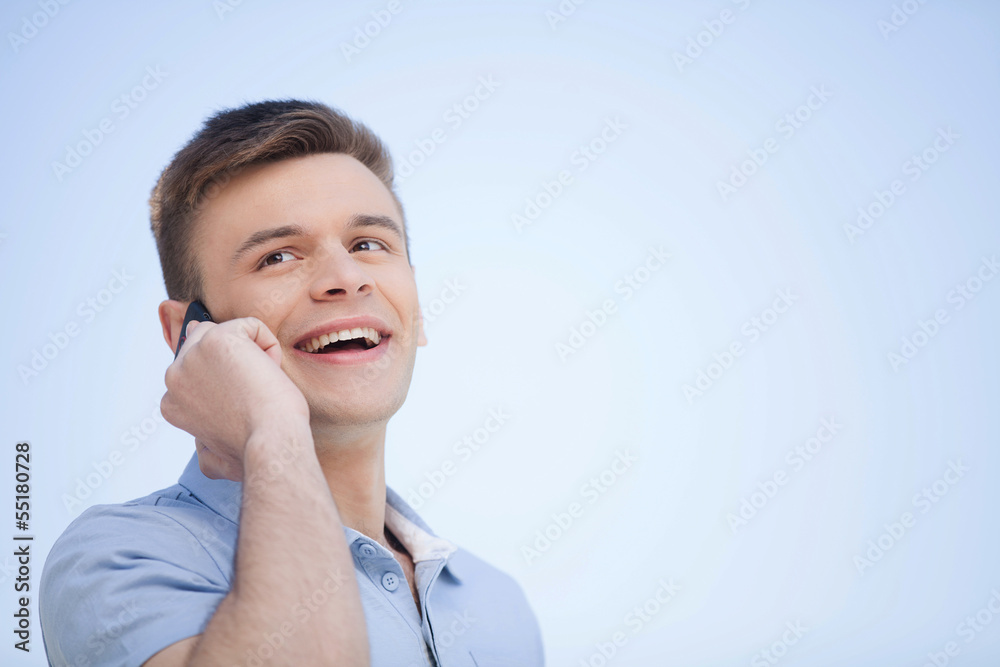 On the phone. Cheerful young man talking on the mobile phone and On the phone. Cheerful young man talking on the mobile phone and