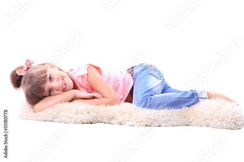 Young child lies on the carpet.