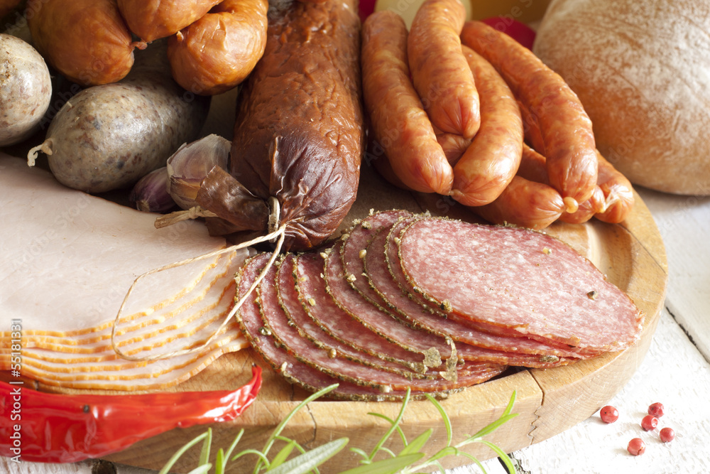 Sausage and meat assortment on cutting board closeup