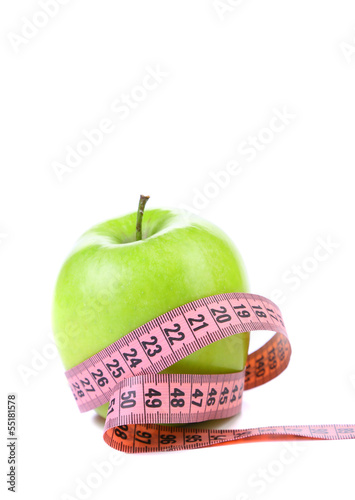 fresh apple with measuring tape.