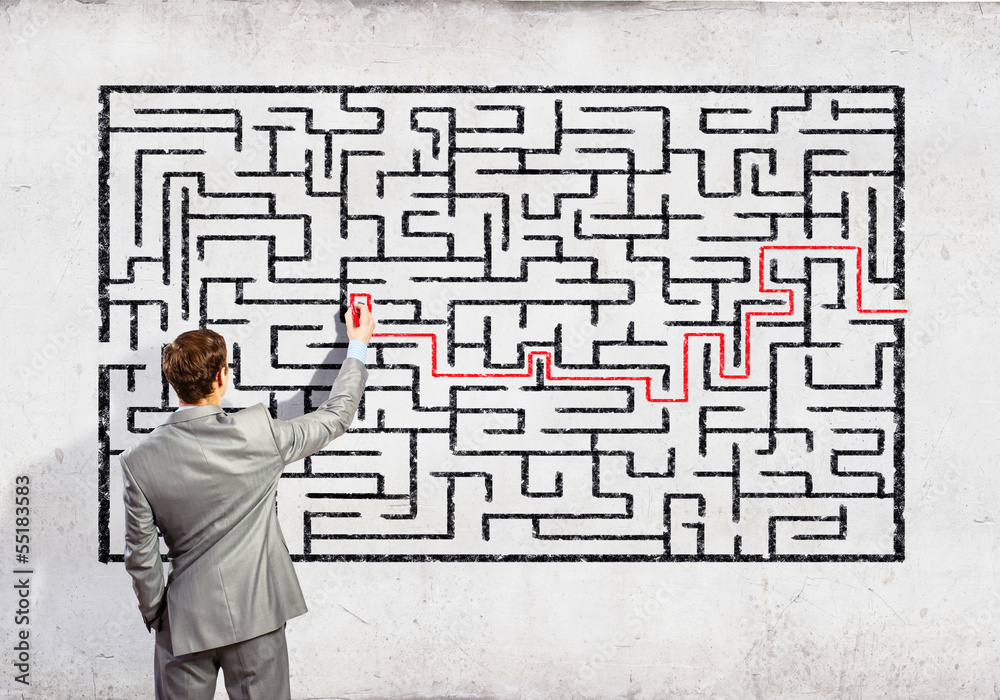 Businessman solving labyrinth problem Businessman solving labyrinth problem