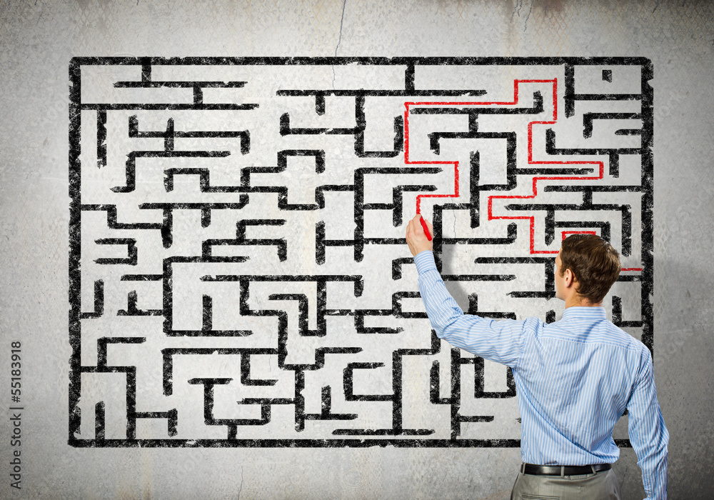Businessman solving labyrinth problem Businessman solving labyrinth problem