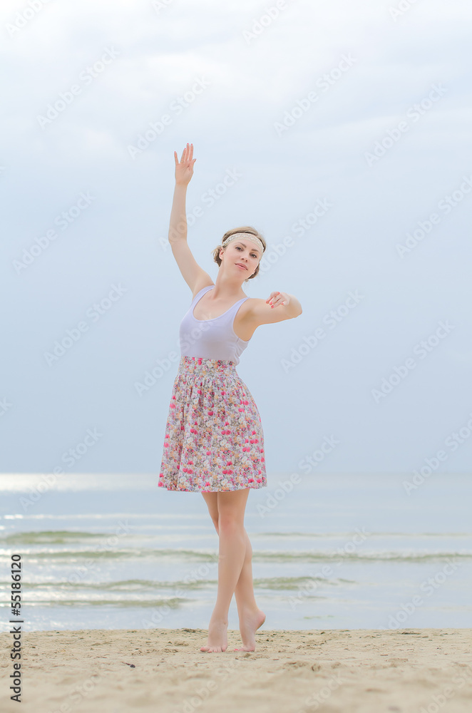 Young woman doing dancing elements near the sea Young woman doing dancing elements near the sea
