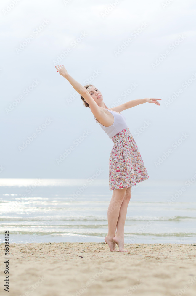 Young woman doing dancing elements near the sea Young woman doing dancing elements near the sea
