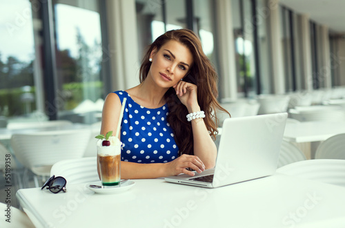 Free Download Beautiful smiling woman working on laptop - GFXLoad