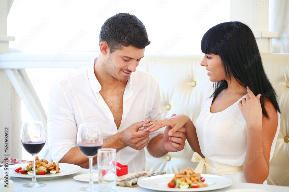 Man proposing engagement ring his woman over restaurant table Man proposing engagement ring his woman over restaurant table