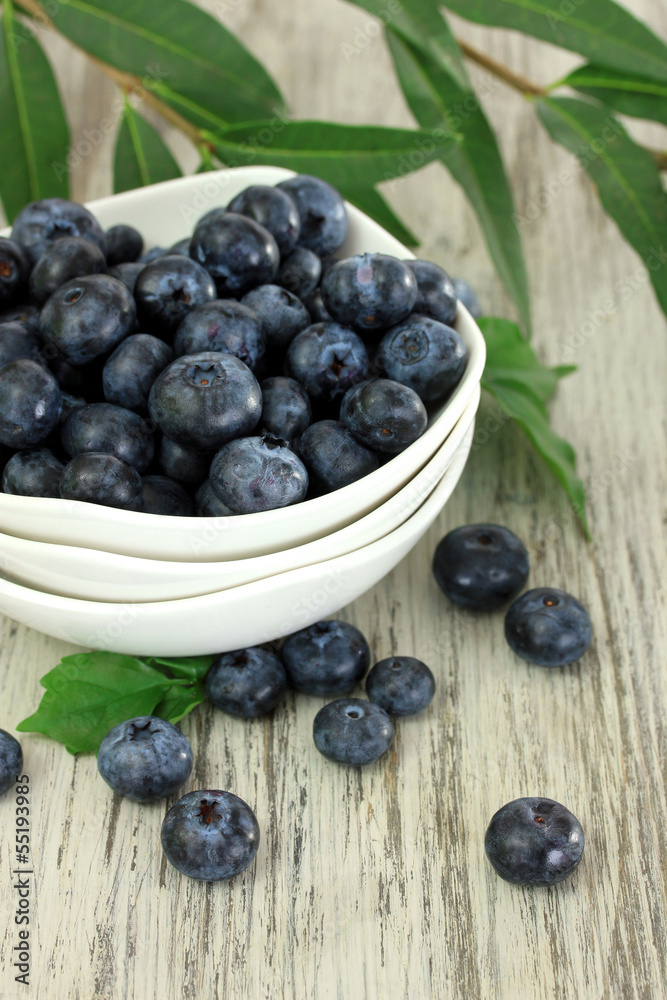 Blueberries in bowls on wooden table Blueberries in bowls on wooden table